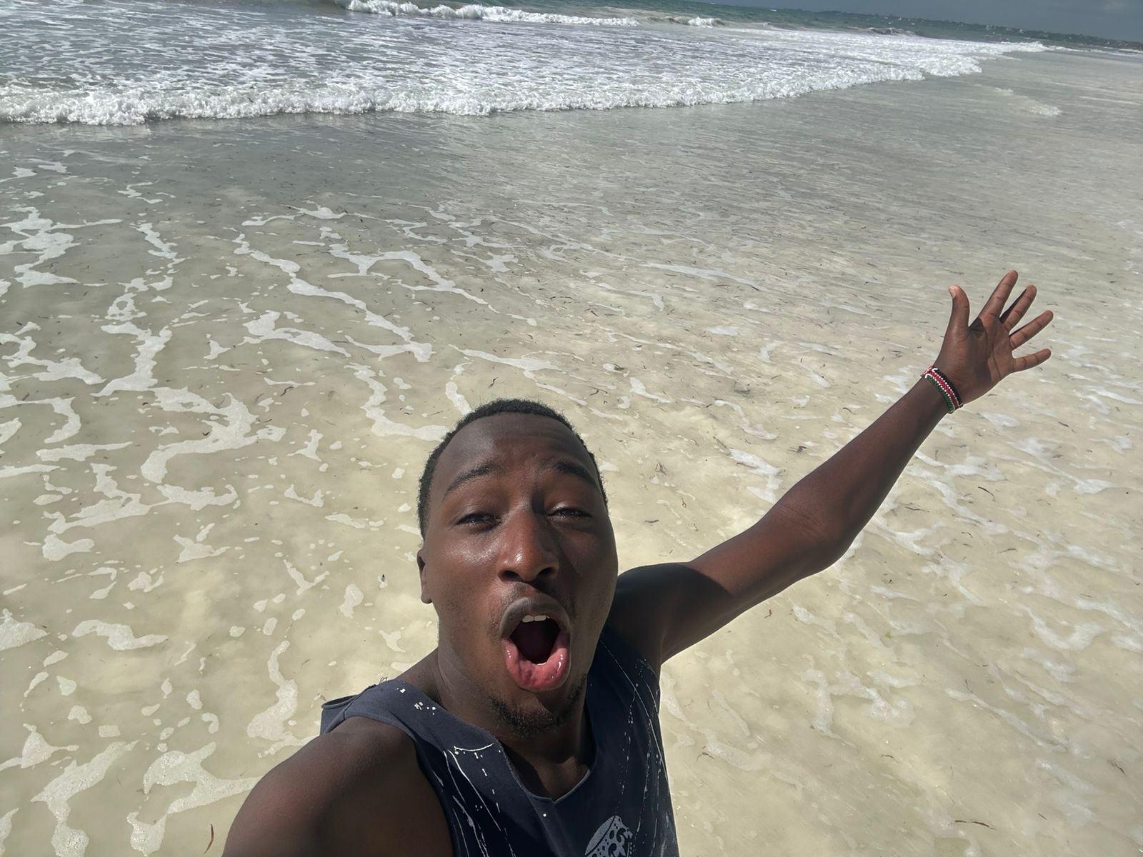 Ian at the beach with arms wide open